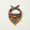 Highland plaid dog bandana in bright orange, teal, red and green tartan, tied in a triangle knot